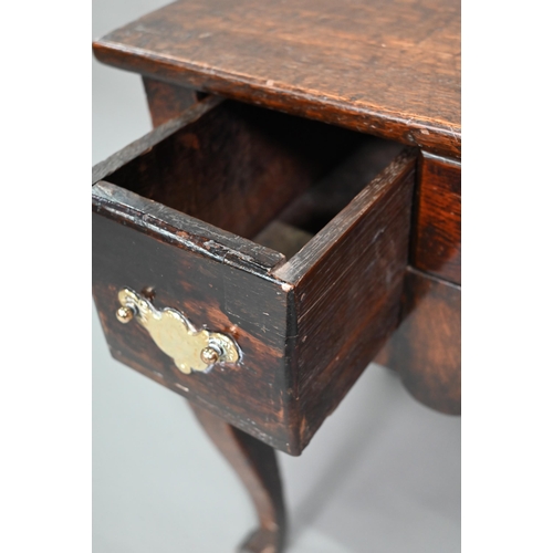 848 - An 18th century oak three drawer side table with fret cut apron raised on four square cabriole legs,... 