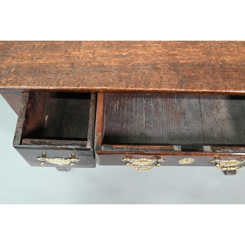 848 - An 18th century oak three drawer side table with fret cut apron raised on four square cabriole legs,... 