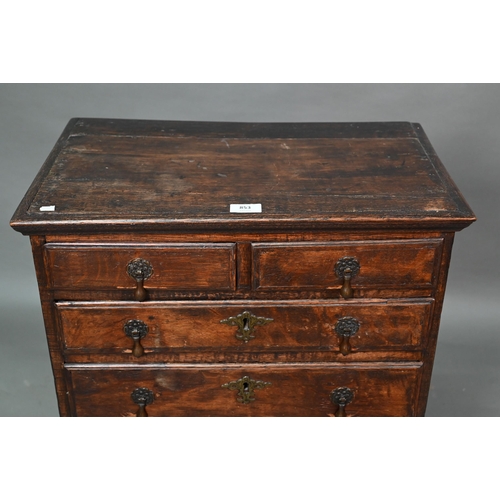 853 - A diminutive George II country oak chest on stand, with two short over three long graduated drawers,... 