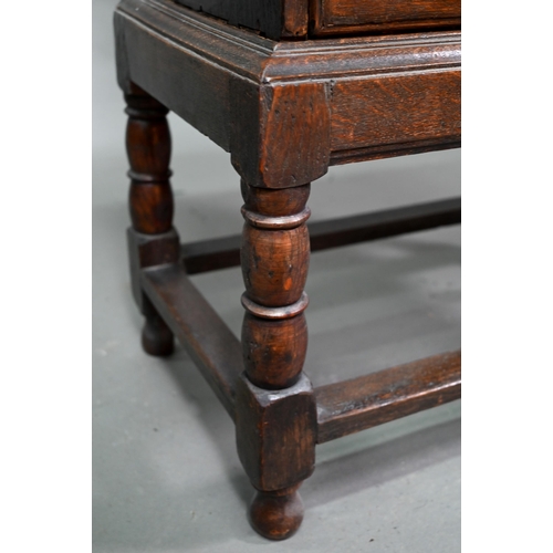 853 - A diminutive George II country oak chest on stand, with two short over three long graduated drawers,... 