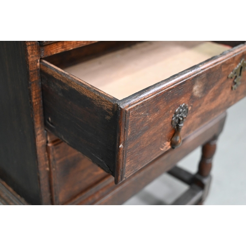 853 - A diminutive George II country oak chest on stand, with two short over three long graduated drawers,... 