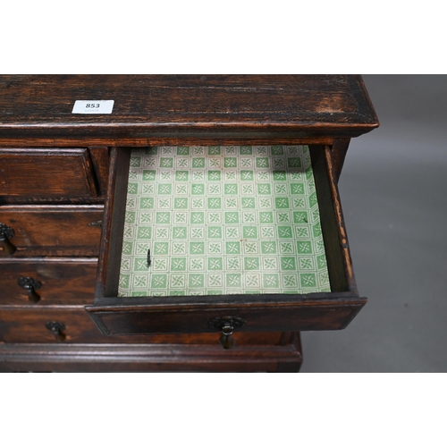 853 - A diminutive George II country oak chest on stand, with two short over three long graduated drawers,... 