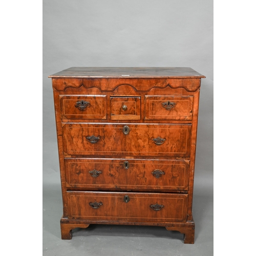 855 - An early 18th century walnut chest of three short over three long graduated drawers, raised on shape... 