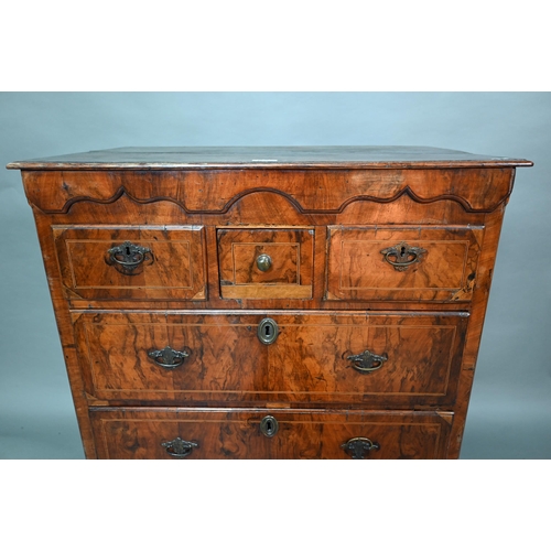 855 - An early 18th century walnut chest of three short over three long graduated drawers, raised on shape... 