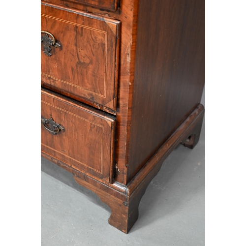 855 - An early 18th century walnut chest of three short over three long graduated drawers, raised on shape... 