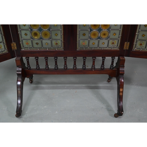 857 - A good Arts & Crafts stained and leaded glass folding screen, the three folding walnut framed pa... 