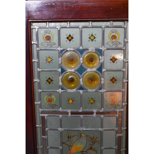 857 - A good Arts & Crafts stained and leaded glass folding screen, the three folding walnut framed pa... 