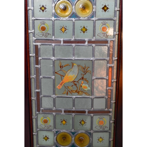 857 - A good Arts & Crafts stained and leaded glass folding screen, the three folding walnut framed pa... 