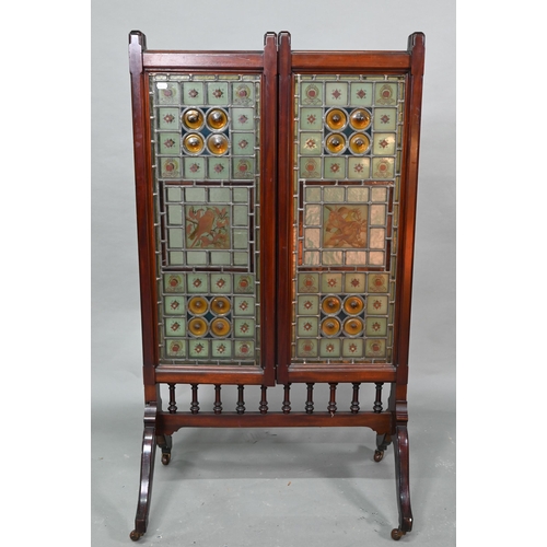 857 - A good Arts & Crafts stained and leaded glass folding screen, the three folding walnut framed pa... 