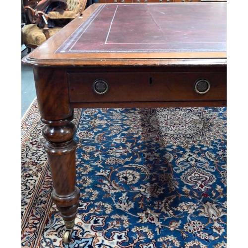 859 - A 19th century mahogany library table, the silver tooled burgundy leather inset top over a pair of f... 