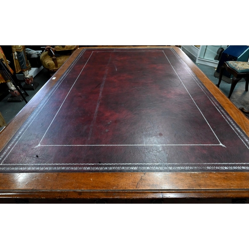 859 - A 19th century mahogany library table, the silver tooled burgundy leather inset top over a pair of f... 