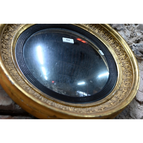 866 - An antique gilt and gesso convex mirror, 36 cm dia.