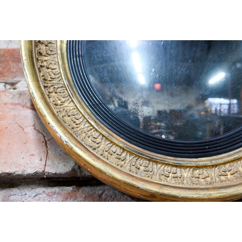 866 - An antique gilt and gesso convex mirror, 36 cm dia.