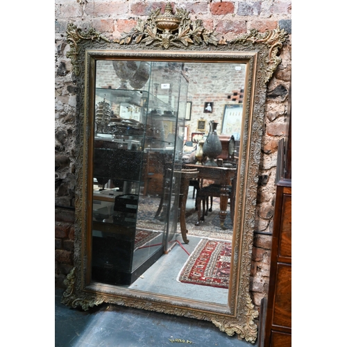 867 - An antique French gilt gesso mirror, surmounted by a garland festooned urn, 155 cm h x 102 cm