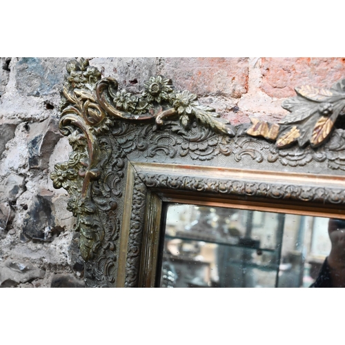 867 - An antique French gilt gesso mirror, surmounted by a garland festooned urn, 155 cm h x 102 cm