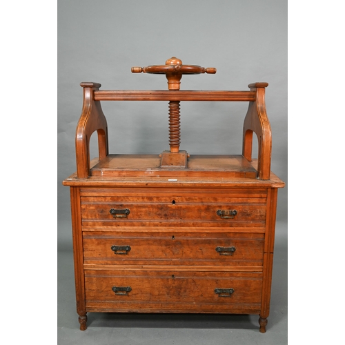 869 - A late 19th century walnut book press chest, the brass bound nautical style adjusting wheel over thr... 