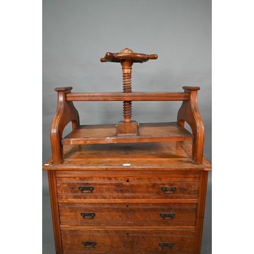 869 - A late 19th century walnut book press chest, the brass bound nautical style adjusting wheel over thr... 