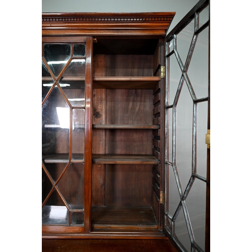 871 - A Victorian mahogany cabinet with pair of Arabic arched panel doors over two long drawers, raised on... 