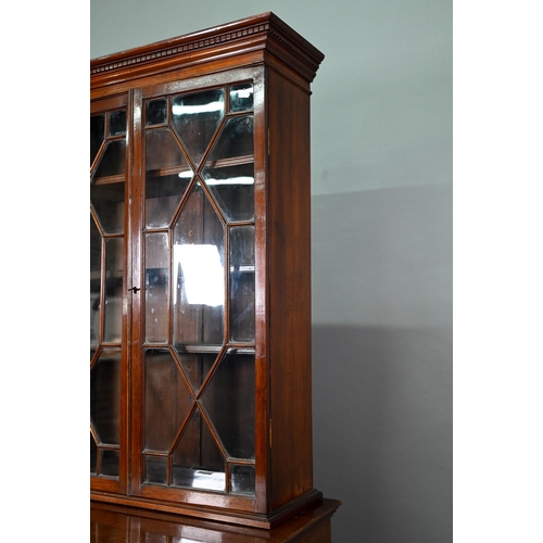 871 - A Victorian mahogany cabinet with pair of Arabic arched panel doors over two long drawers, raised on... 