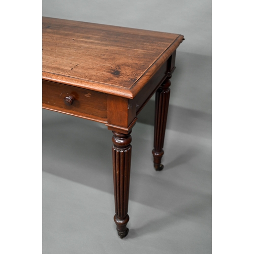 877 - A Victorian mahogany two drawer side table, raised on turned reeded legs to brass castors, 122 cm w ... 