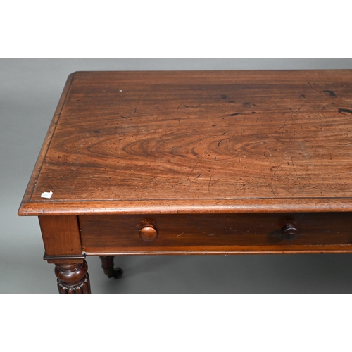 877 - A Victorian mahogany two drawer side table, raised on turned reeded legs to brass castors, 122 cm w ... 