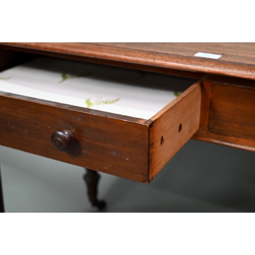 877 - A Victorian mahogany two drawer side table, raised on turned reeded legs to brass castors, 122 cm w ... 