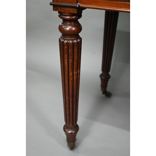 877 - A Victorian mahogany two drawer side table, raised on turned reeded legs to brass castors, 122 cm w ... 