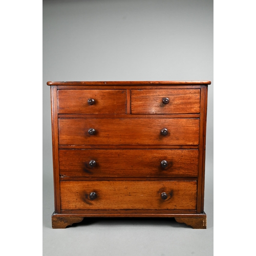 878 - An old miniature mahogany chest of two short over three long graduated drawers, with turned pulls, o... 