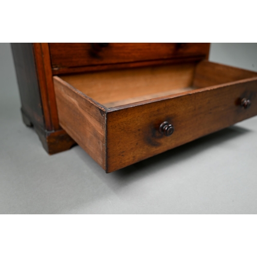 878 - An old miniature mahogany chest of two short over three long graduated drawers, with turned pulls, o... 