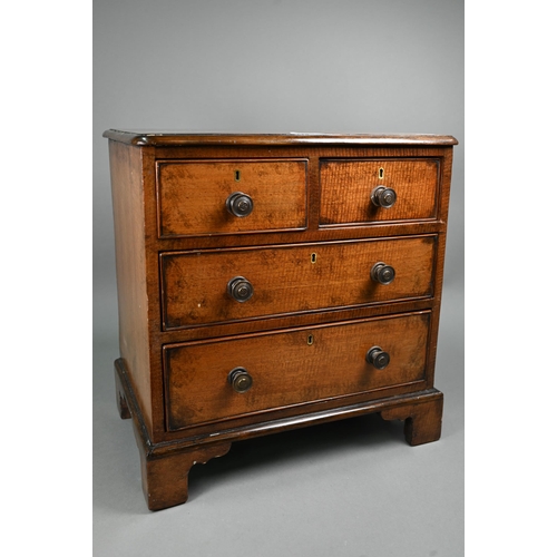 879 - A late 19th century miniature mahogany chest of two short over two long graduated with metal pulls, ... 