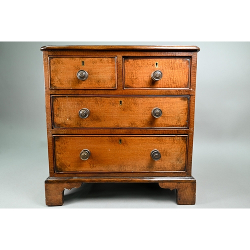 879 - A late 19th century miniature mahogany chest of two short over two long graduated with metal pulls, ... 