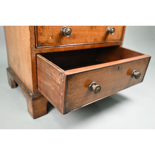 879 - A late 19th century miniature mahogany chest of two short over two long graduated with metal pulls, ... 