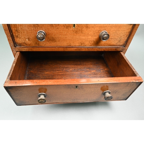 879 - A late 19th century miniature mahogany chest of two short over two long graduated with metal pulls, ... 