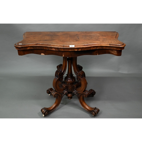 881 - A Victorian walnut card table, the fold over serpentine top with baize lining, raise on moulded clus... 