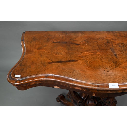 881 - A Victorian walnut card table, the fold over serpentine top with baize lining, raise on moulded clus... 