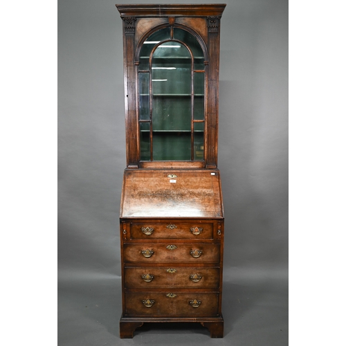 882 - A diminutive Georgian style cross-banded walnut bureau bookcase, the arched astragal glazed cabinet ... 