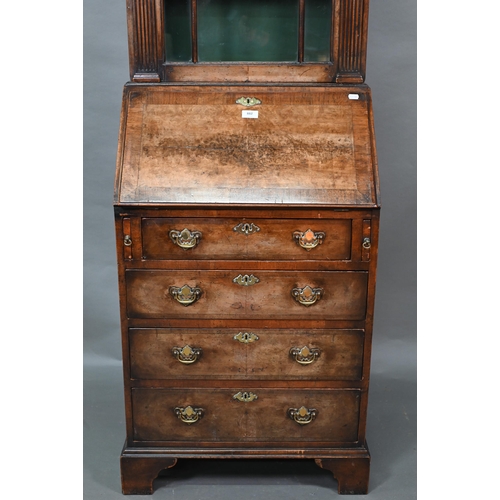 882 - A diminutive Georgian style cross-banded walnut bureau bookcase, the arched astragal glazed cabinet ... 