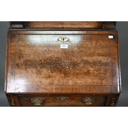 882 - A diminutive Georgian style cross-banded walnut bureau bookcase, the arched astragal glazed cabinet ... 