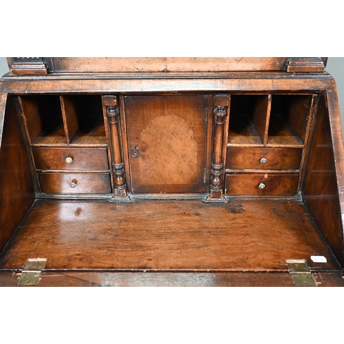 882 - A diminutive Georgian style cross-banded walnut bureau bookcase, the arched astragal glazed cabinet ... 