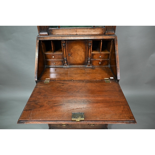 882 - A diminutive Georgian style cross-banded walnut bureau bookcase, the arched astragal glazed cabinet ... 