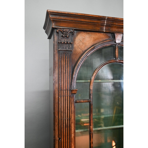 882 - A diminutive Georgian style cross-banded walnut bureau bookcase, the arched astragal glazed cabinet ... 