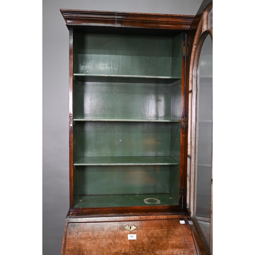 882 - A diminutive Georgian style cross-banded walnut bureau bookcase, the arched astragal glazed cabinet ... 