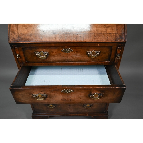 882 - A diminutive Georgian style cross-banded walnut bureau bookcase, the arched astragal glazed cabinet ... 