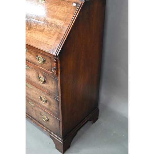 882 - A diminutive Georgian style cross-banded walnut bureau bookcase, the arched astragal glazed cabinet ... 