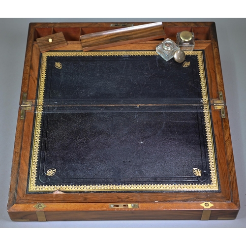 883 - A Victorian brass-bound mahogany writing slope, the interior with leather surface and two glass ink ... 