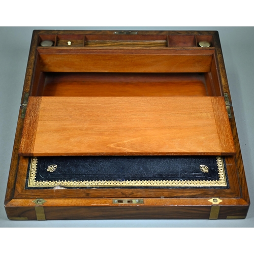 883 - A Victorian brass-bound mahogany writing slope, the interior with leather surface and two glass ink ... 