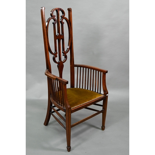 884 - An Arts & Crafts Liberty style carver chair, with shaped back and fabric seat