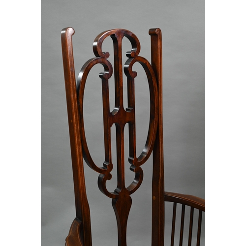 884 - An Arts & Crafts Liberty style carver chair, with shaped back and fabric seat