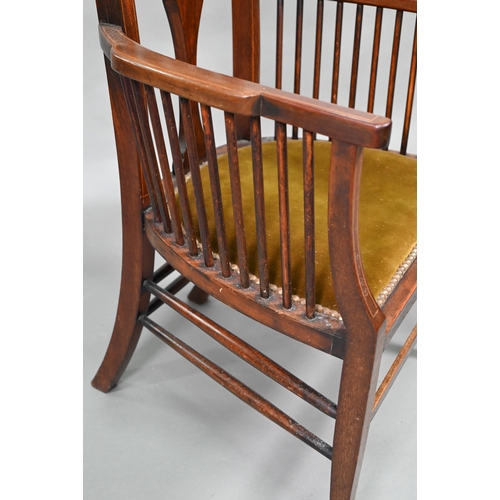 884 - An Arts & Crafts Liberty style carver chair, with shaped back and fabric seat