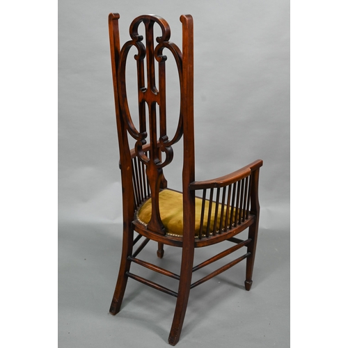 884 - An Arts & Crafts Liberty style carver chair, with shaped back and fabric seat